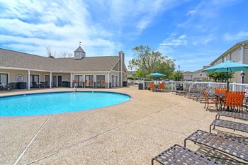 Our resort style pool is surrounded by chairs and umbrellas
